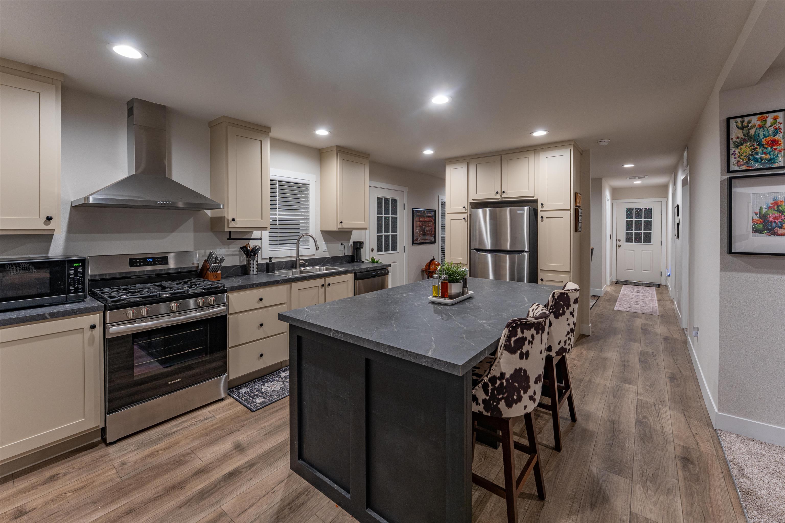 264 Holly Berry Way Fruita, CO 81521 - Photo 2 of 27 a kitchen with stainless steel appliances a stove a sink a oven a dining table and chairs
