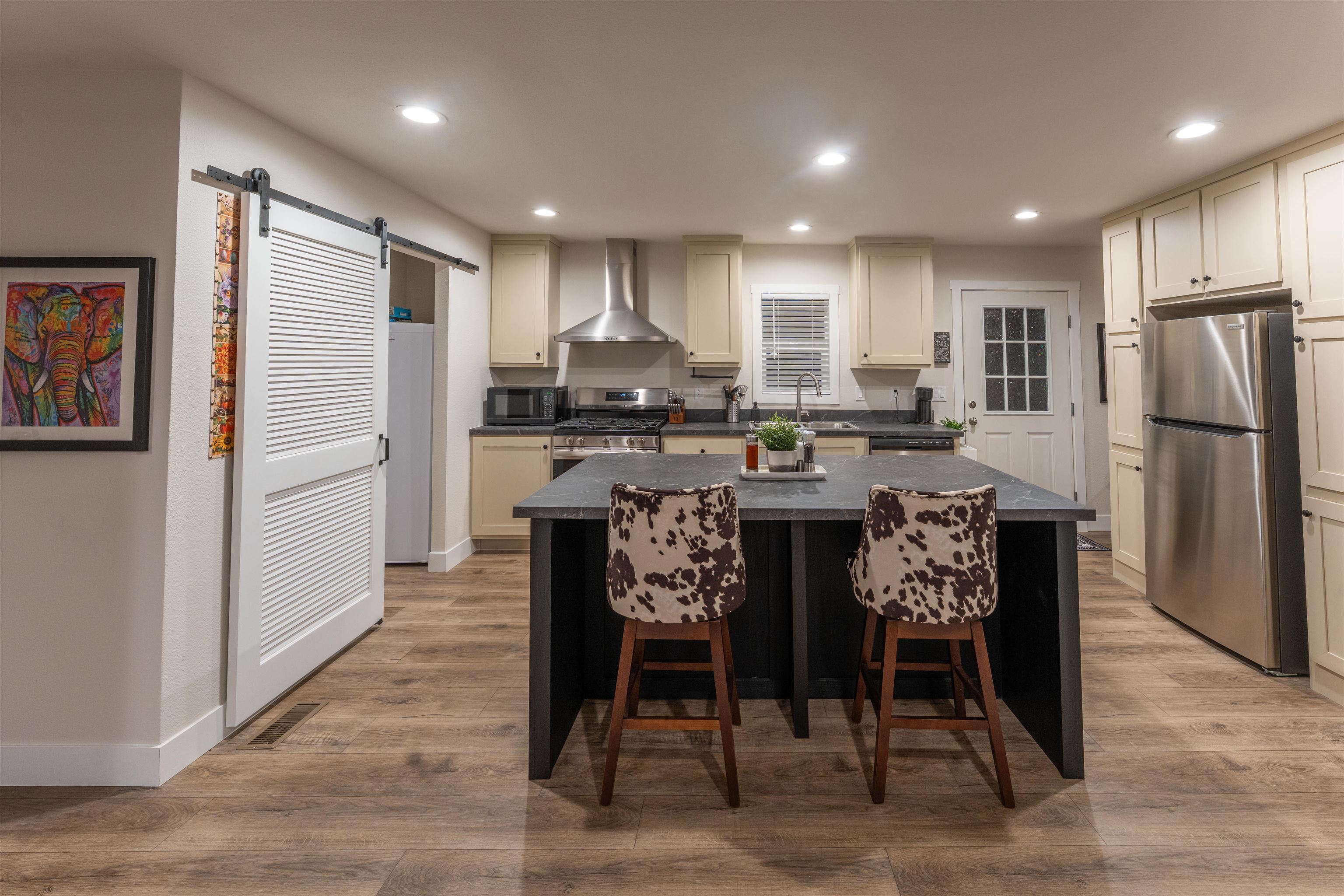 264 Holly Berry Way Fruita, CO 81521 - Photo 3 of 27 a kitchen with stainless steel appliances granite countertop a stove a refrigerator a oven a white table and chairs