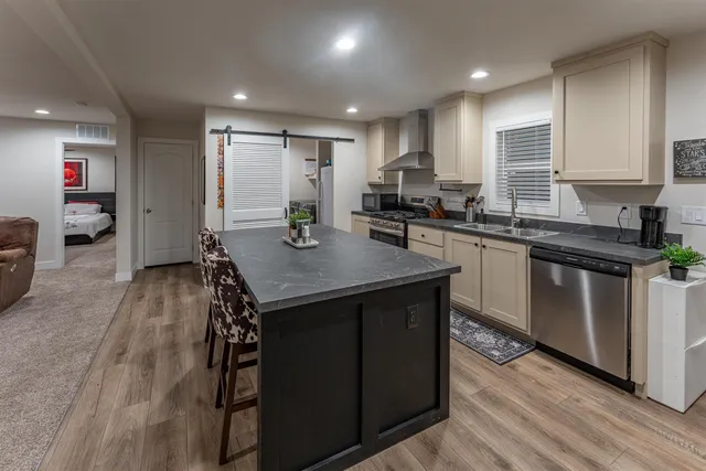 a kitchen with a sink refrigerator and cabinets