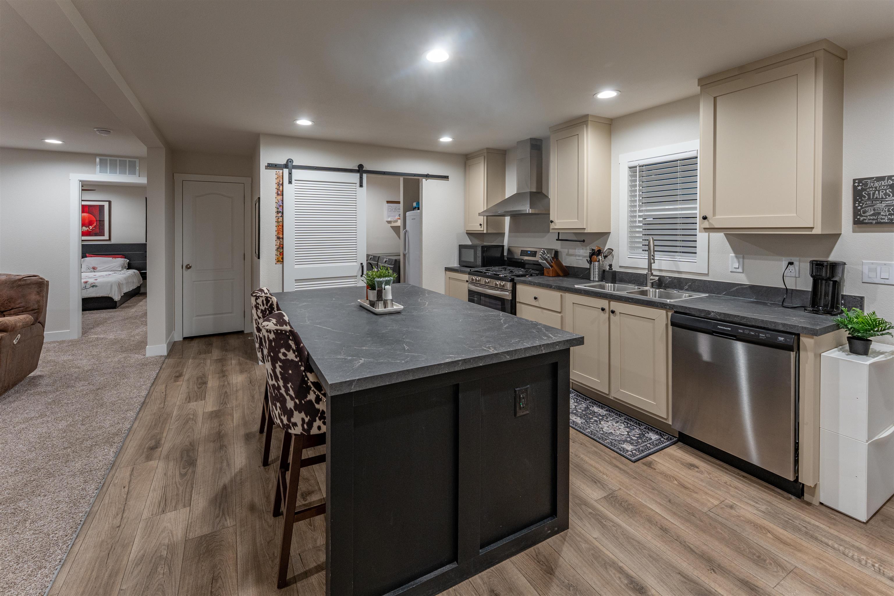264 Holly Berry Way Fruita, CO 81521 - Photo 4 of 27 a kitchen with a sink refrigerator and cabinets