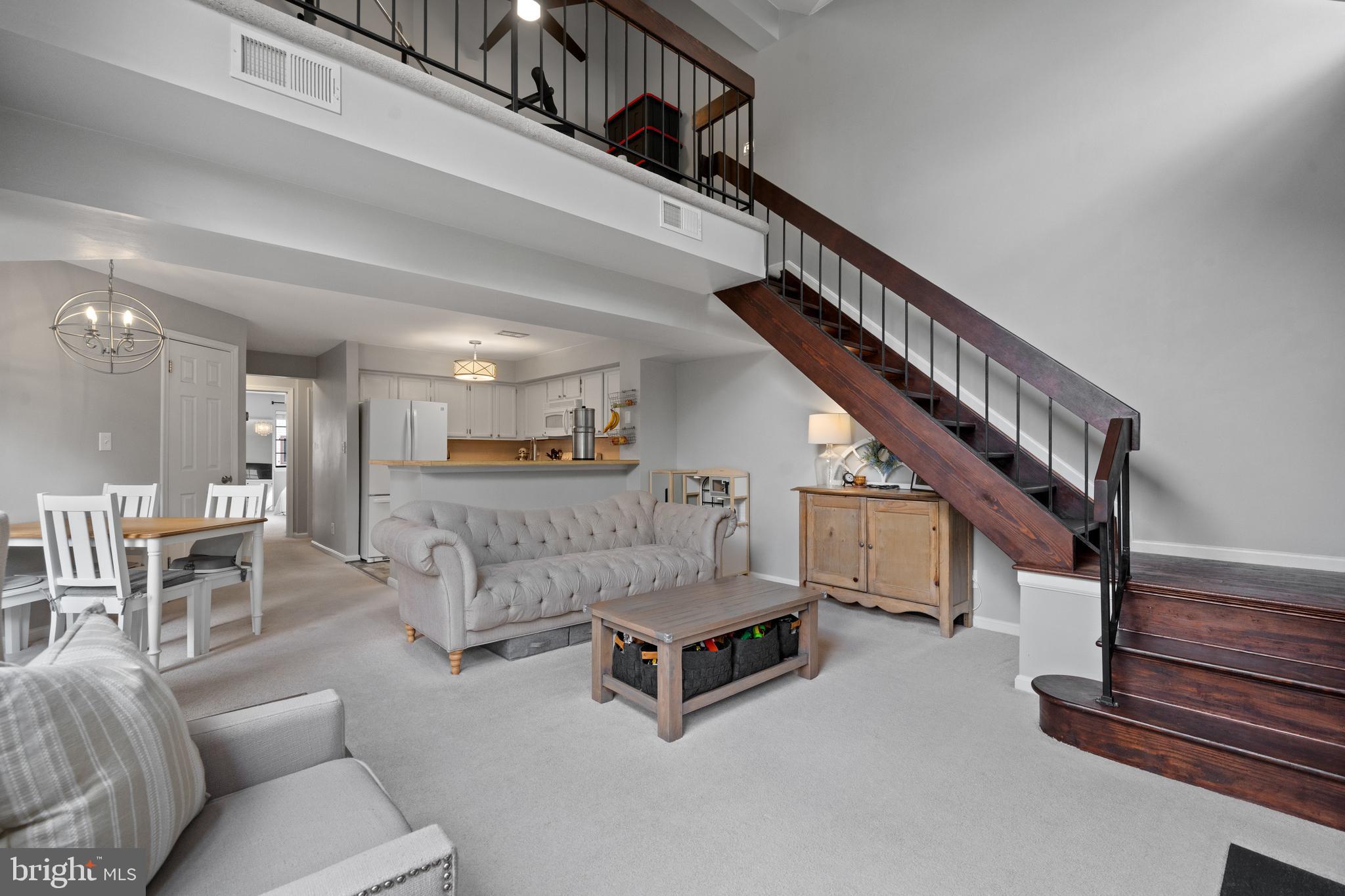 6022 Curtier Drive, Unit E Alexandria, VA 22310 - Photo 13 of 38 a living room with furniture and stairs
