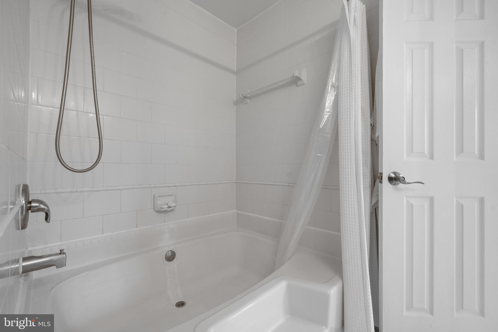 6022 Curtier Drive, Unit E Alexandria, VA 22310 - Photo 28 of 38 a bathroom with a bath tub and a shower