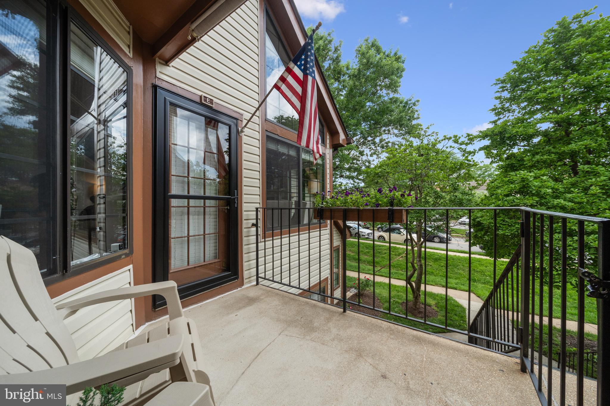 6022 Curtier Drive, Unit E Alexandria, VA 22310 - Photo 32 of 38 a view of a house with a floor to ceiling window and wooden fence