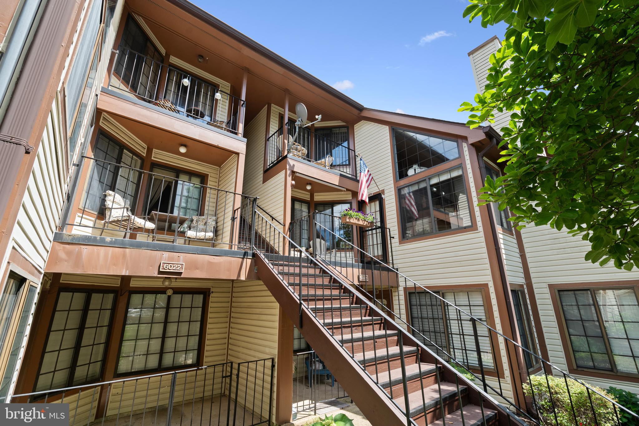 6022 Curtier Drive, Unit E Alexandria, VA 22310 - Photo 33 of 38 a view of a brick house with large windows and furniture