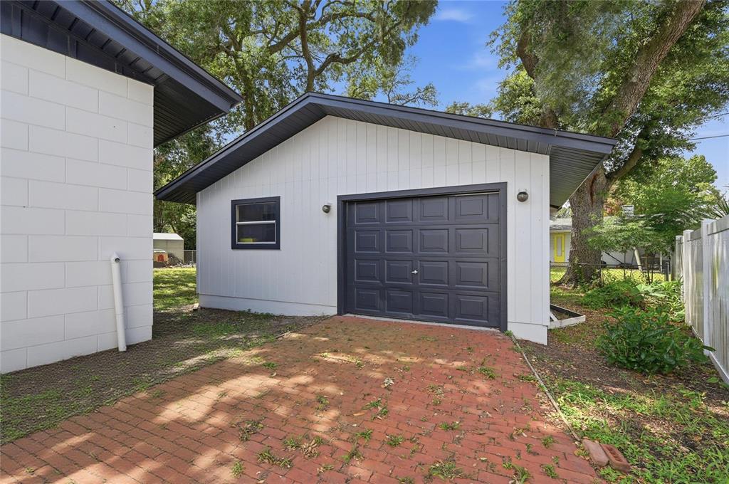 1946 Strathaven Road Winter Park, FL 32792 - Photo 2 of 37 a view of a house with a small yard and garage
