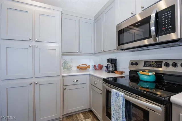 a kitchen with stainless steel appliances granite countertop a stove a microwave and cabinets