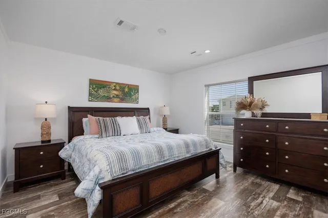 a bedroom with a bed and a dresser