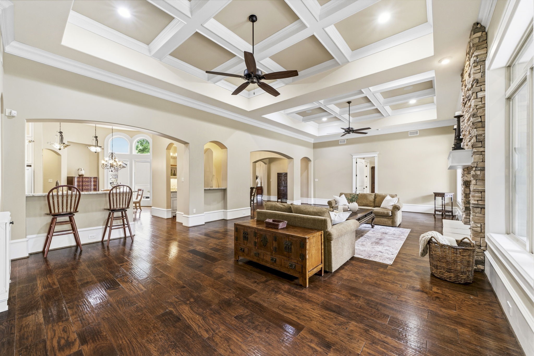 27402 Jacob's Path Lane Spring, TX 77386 - Photo 12 of 48 Spacious open-concept living area seamlessly connects to the kitchen, featuring a breakfast bar, separate bar/butler’s pantry, and adjacent dining room. Elegant coffered ceilings add architectural charm, while 12-inch baseboards with integrated outlets provide both style and functionality. Two ceiling fans enhance comfort throughout this inviting gathering space.
Absolutely. For that photo, a polished MLS-style listing de