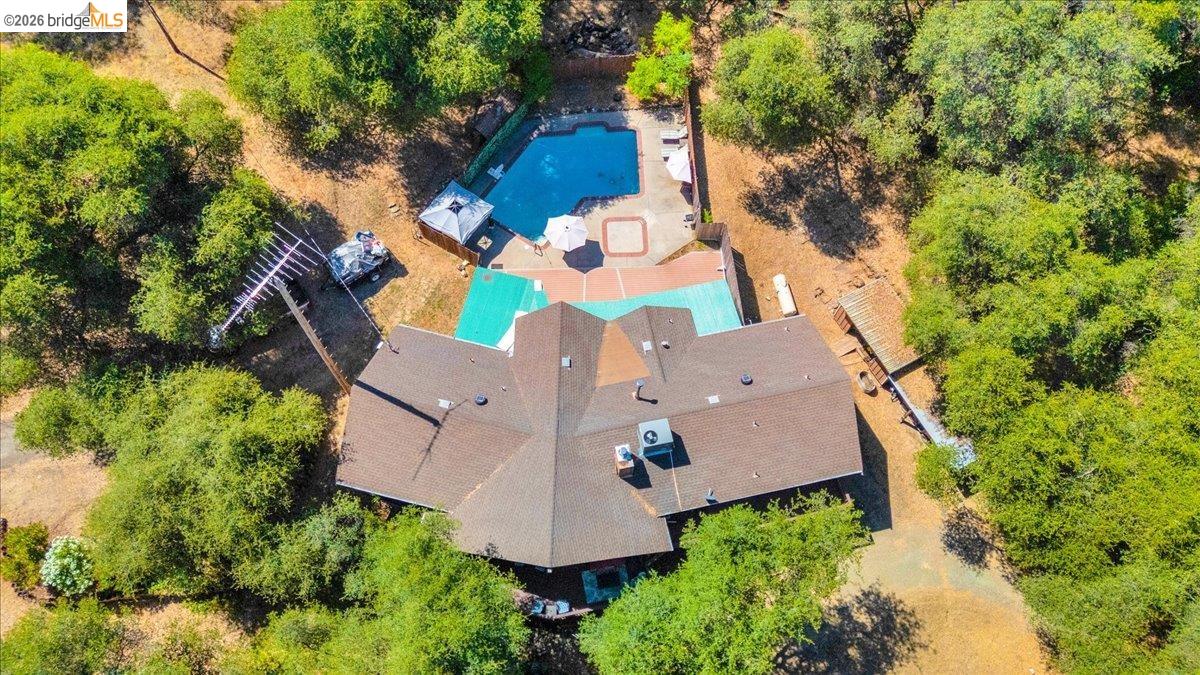 8733 Fraguero Road Sonora, CA 95370 - Photo 3 of 73 Aerial perspective showcasing a multi-winged roofline, an outdoor swimming pool, and a surrounding deck