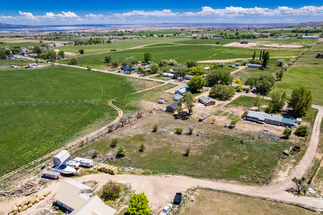 1043 East 4000th Street South Vernal, UT 84078 - Photo 22 of 31 Expansive agricultural landscape featuring large green fields and scattered residential properties
