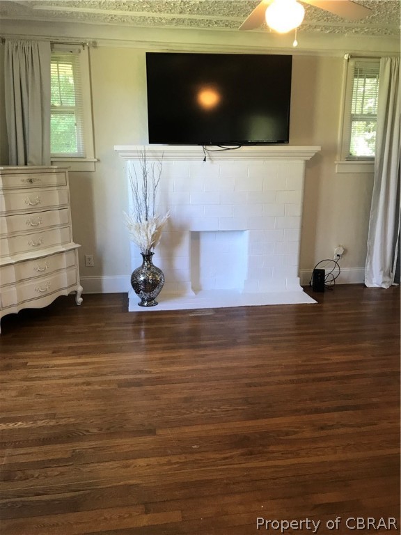 347 Lillys Neck Road Moon, VA 23119 - Photo 8 of 45 Unfurnished living room featuring a healthy amount of sunlight, dark hardwood / wood-style flooring, and ceiling fan