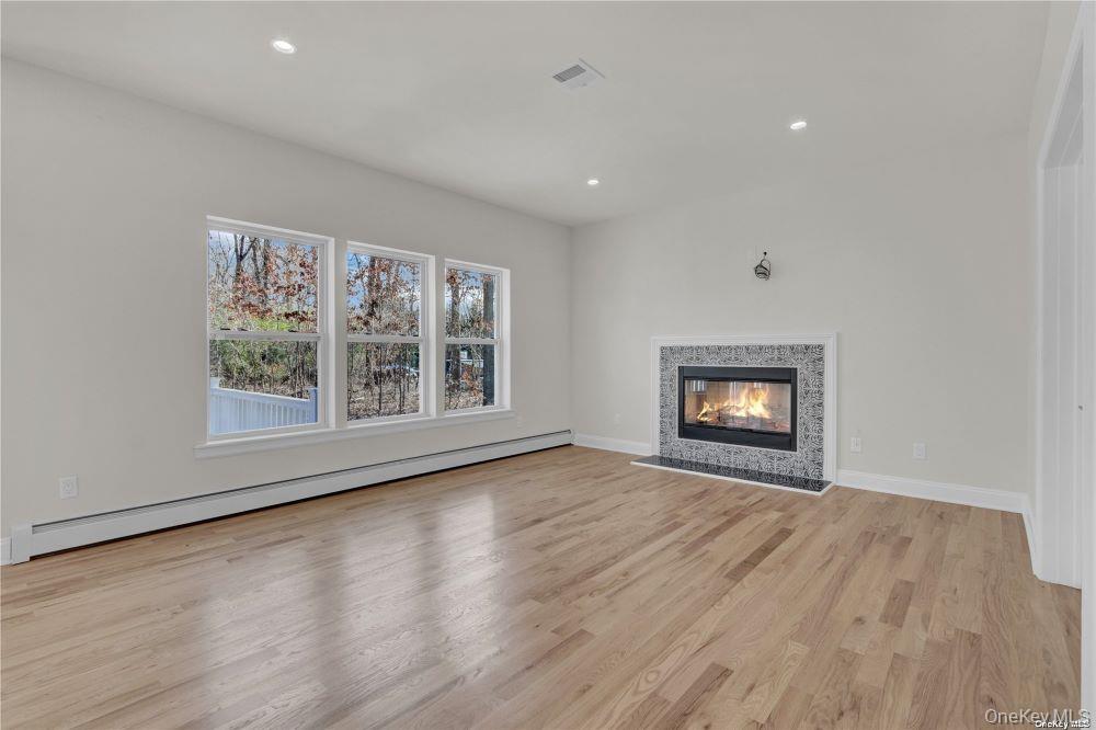 Lot 3 Westfield Road Coram, NY 11727 - Photo 11 of 25 a view of an empty room with a window and wooden floor