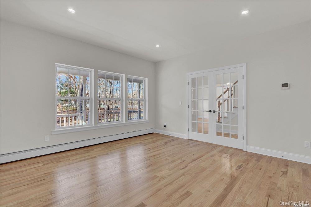 Lot 3 Westfield Road Coram, NY 11727 - Photo 4 of 25 a view of an empty room with wooden floor and a window