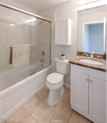 a bathroom with a granite countertop toilet a sink and bathtub