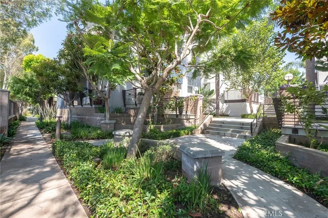 a view of a patio with table and chairs and a large tree