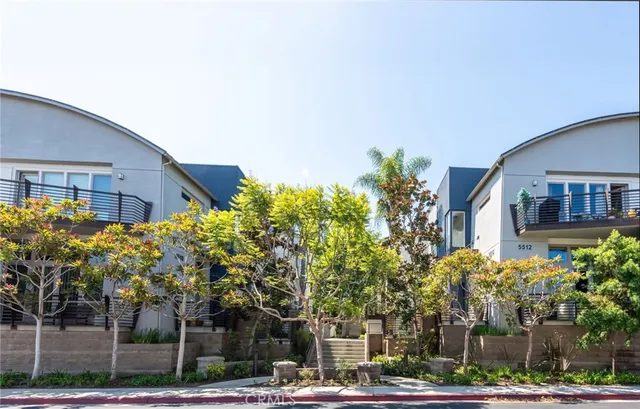 a front view of a building with tree s