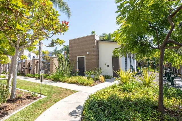 a front view of a house with a yard and tree