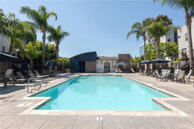 a swimming pool with outdoor seating and yard