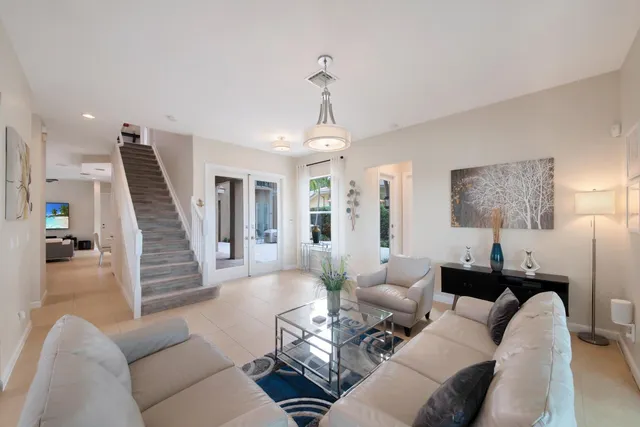 a living room with furniture and a chandelier