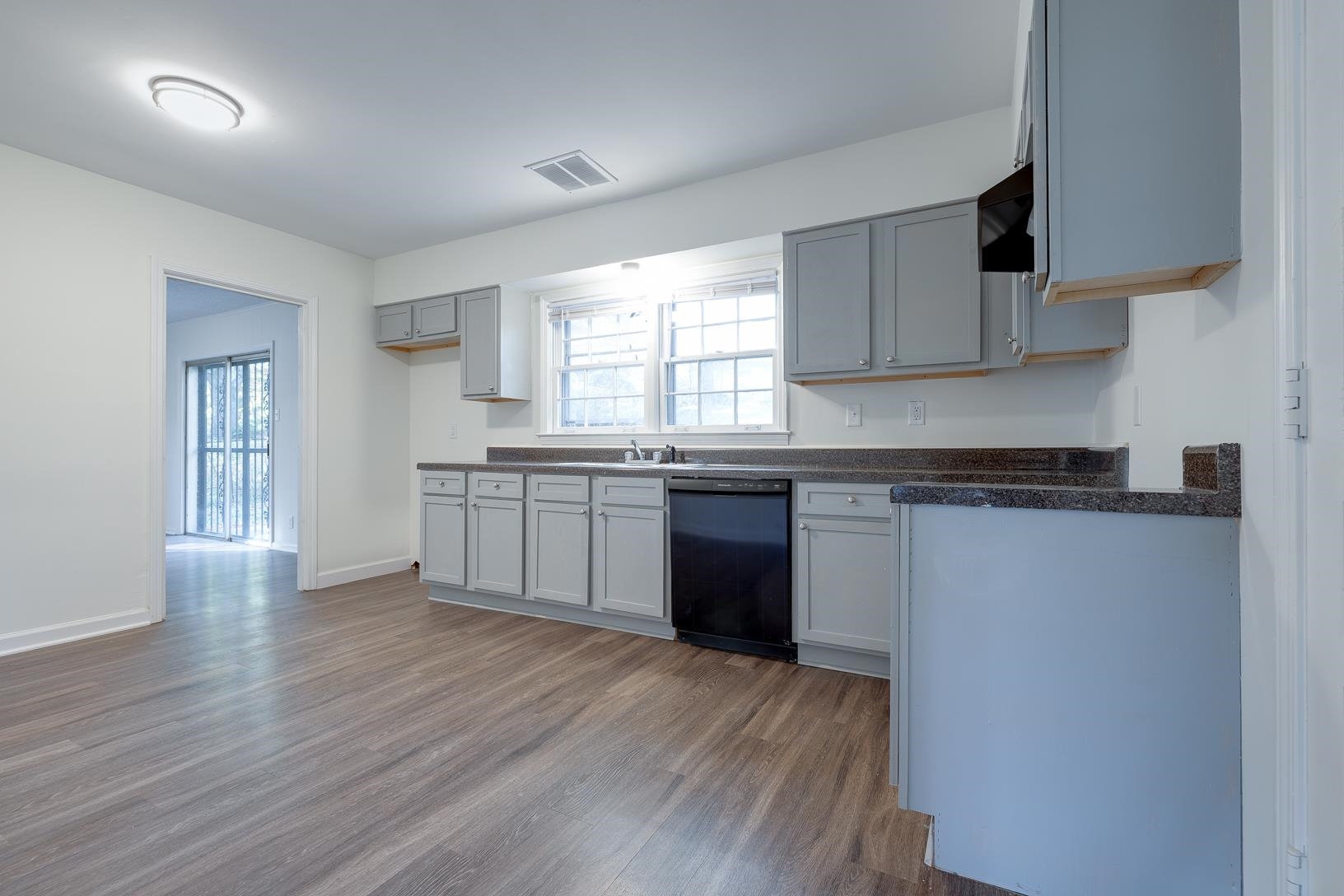 2790 James Road Memphis, TN 38127 - Photo 7 of 19 a kitchen with granite countertop wooden floors and white stainless steel appliances