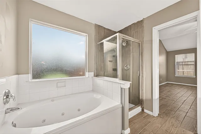 a bathroom with a bathtub and a shower