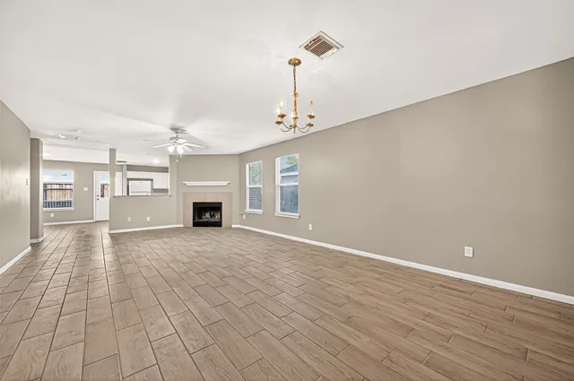 wooden floor in an empty room with a fireplace