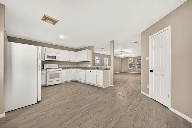 a view of kitchen with wooden floor