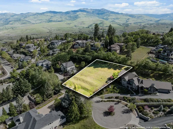 an aerial view of a house with a yard and pool