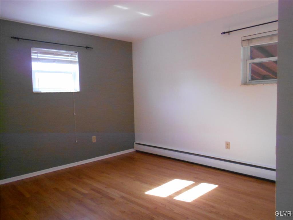 851 Elm Road Hellertown, PA 18055 - Photo 11 of 17 an empty room with wooden floor and windows