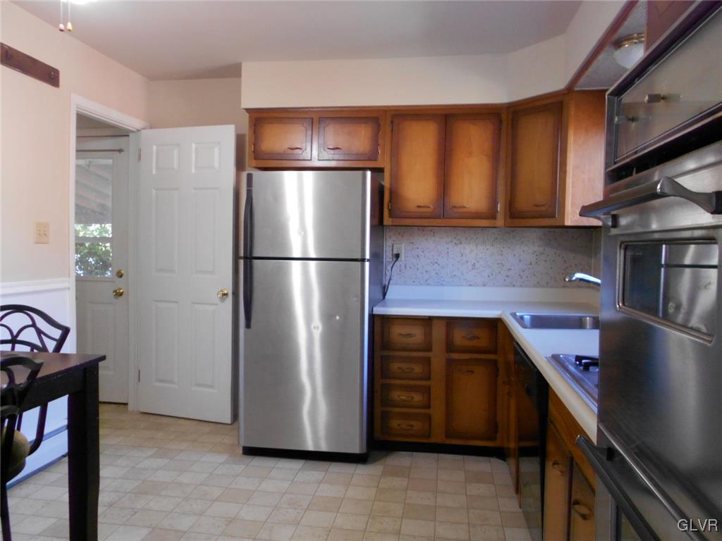 851 Elm Road Hellertown, PA 18055 - Photo 6 of 17 a kitchen with stainless steel appliances granite countertop a refrigerator and a stove top oven
