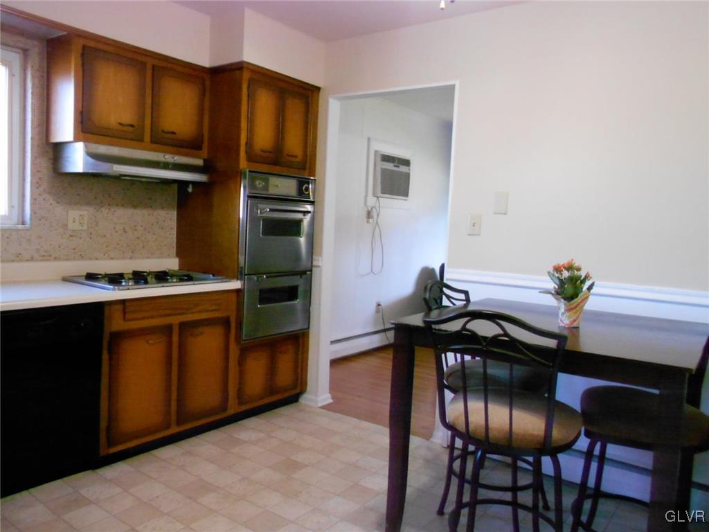 851 Elm Road Hellertown, PA 18055 - Photo 7 of 17 a kitchen with stainless steel appliances granite countertop a stove a sink dishwasher and cabinets