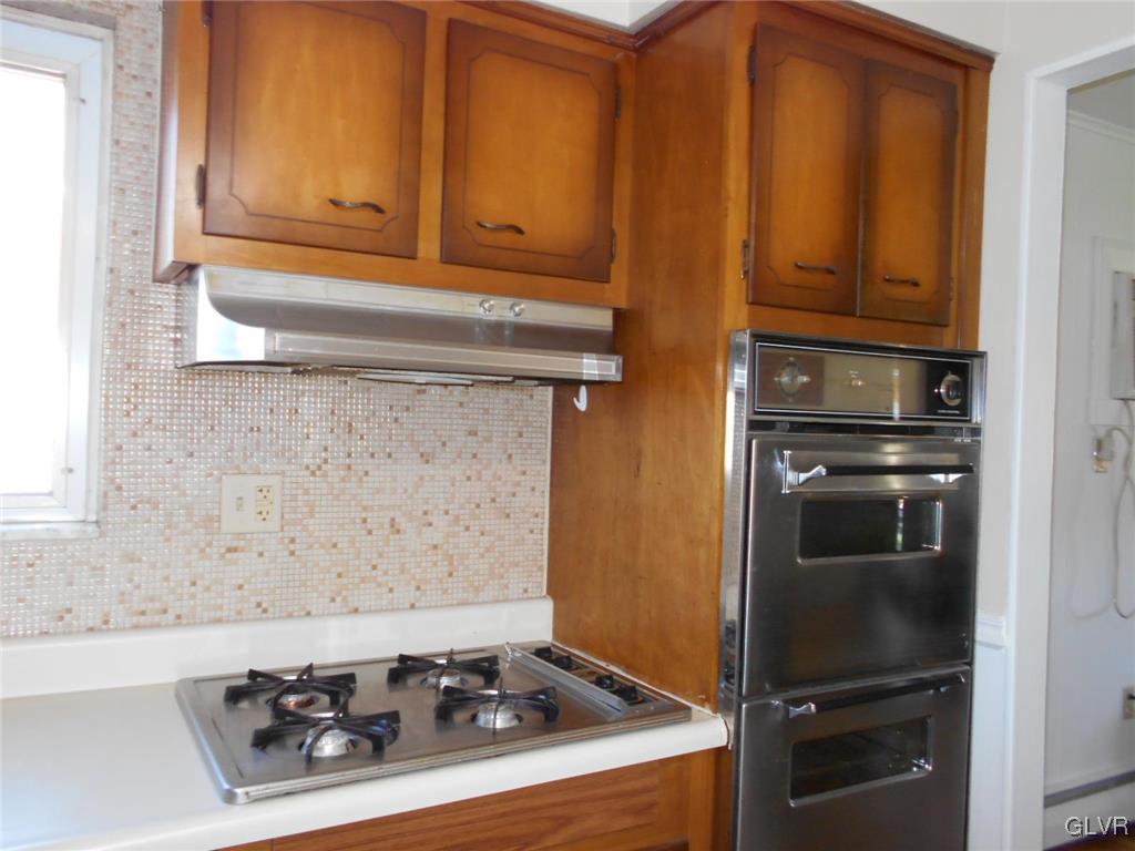 851 Elm Road Hellertown, PA 18055 - Photo 8 of 17 a kitchen with granite countertop a stove and a cabinet