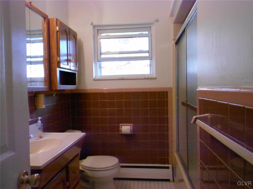 851 Elm Road Hellertown, PA 18055 - Photo 9 of 17 a bathroom with a toilet a sink and a mirror