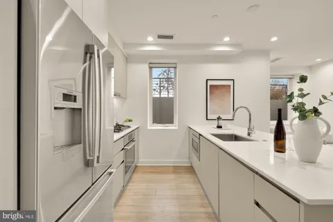 a spacious bathroom with a double vanity sink a mirror and a bathtub