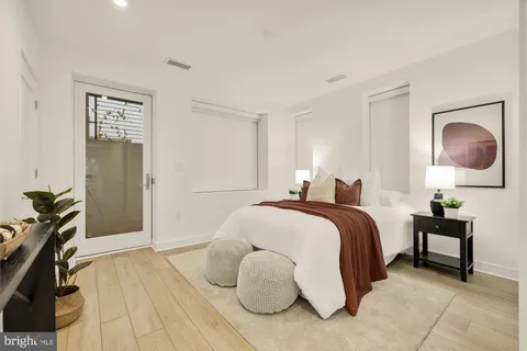 a bedroom with a bed and a lamp