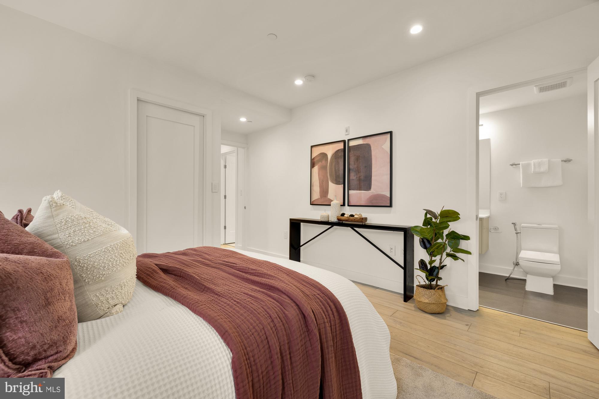 1101 Q Street Northwest, Unit 103 Washington, DC 20001 - Photo 15 of 26 a bedroom with a balcony a bed and a couch