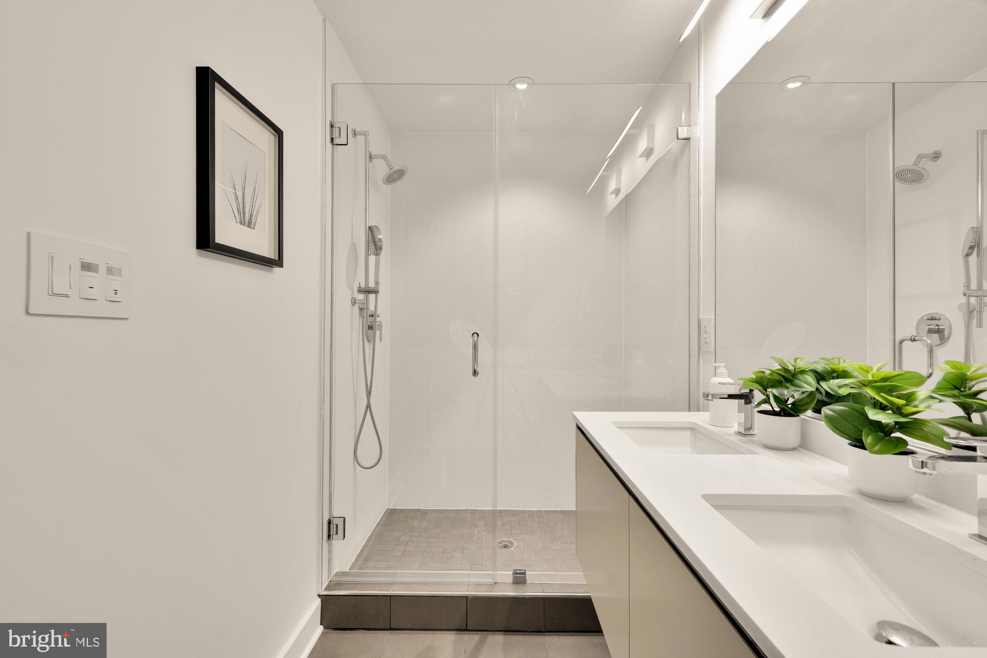 1101 Q Street Northwest, Unit 103 Washington, DC 20001 - Photo 17 of 26 a bathroom with a shower sink and mirror