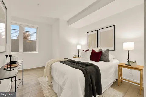 a bedroom with a bed and a lamp