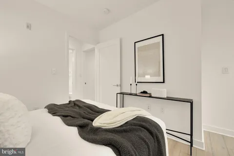 a bedroom with a bed and a mirror