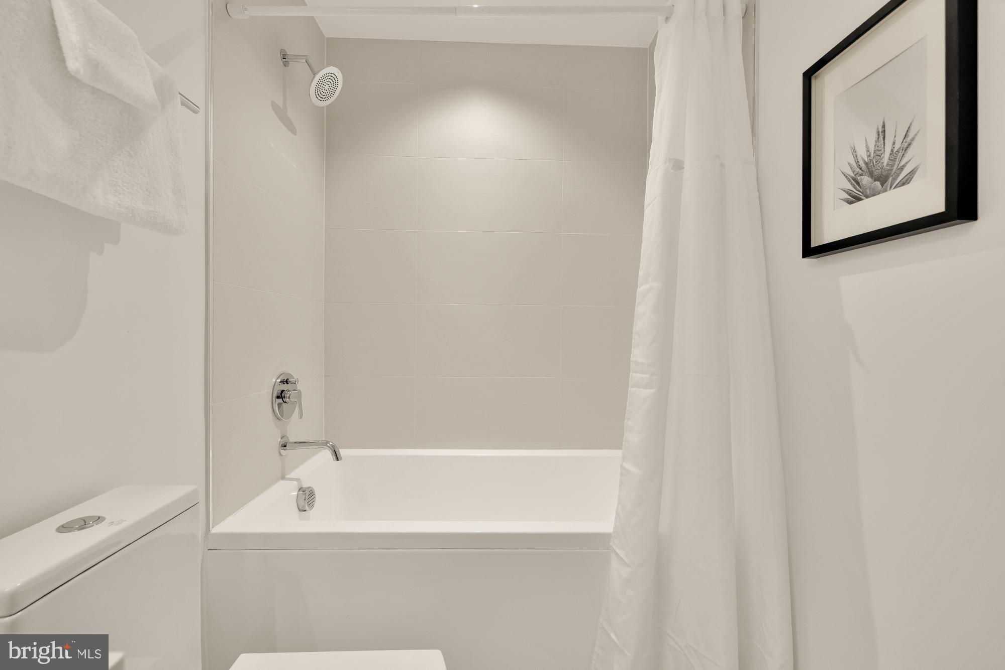 1101 Q Street Northwest, Unit 103 Washington, DC 20001 - Photo 24 of 26 a bathroom with a bathtub and a shower