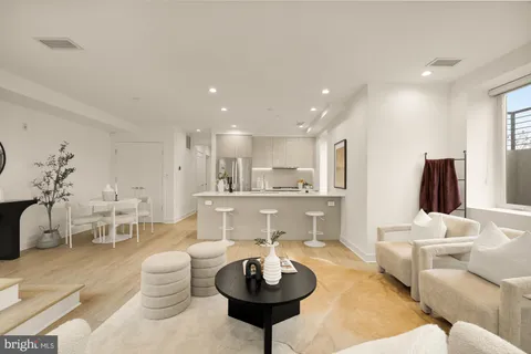 a living room with furniture a window and a table