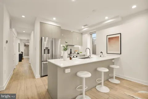 a kitchen with stainless steel appliances granite countertop a sink and a refrigerator