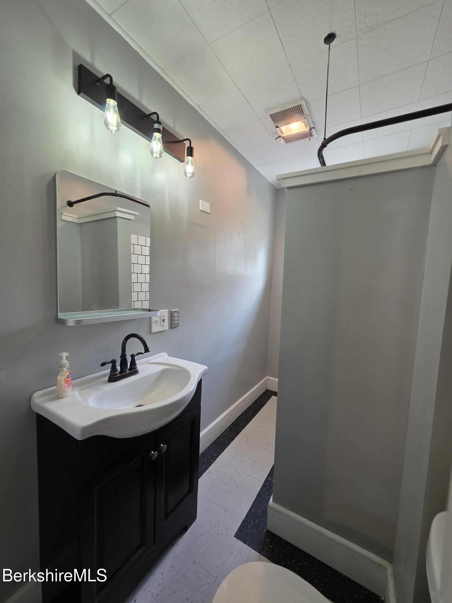 75 North Summer Street, Unit 2 Adams, MA 01220 - Photo 12 of 15 a bathroom with a sink vanity and a mirror
