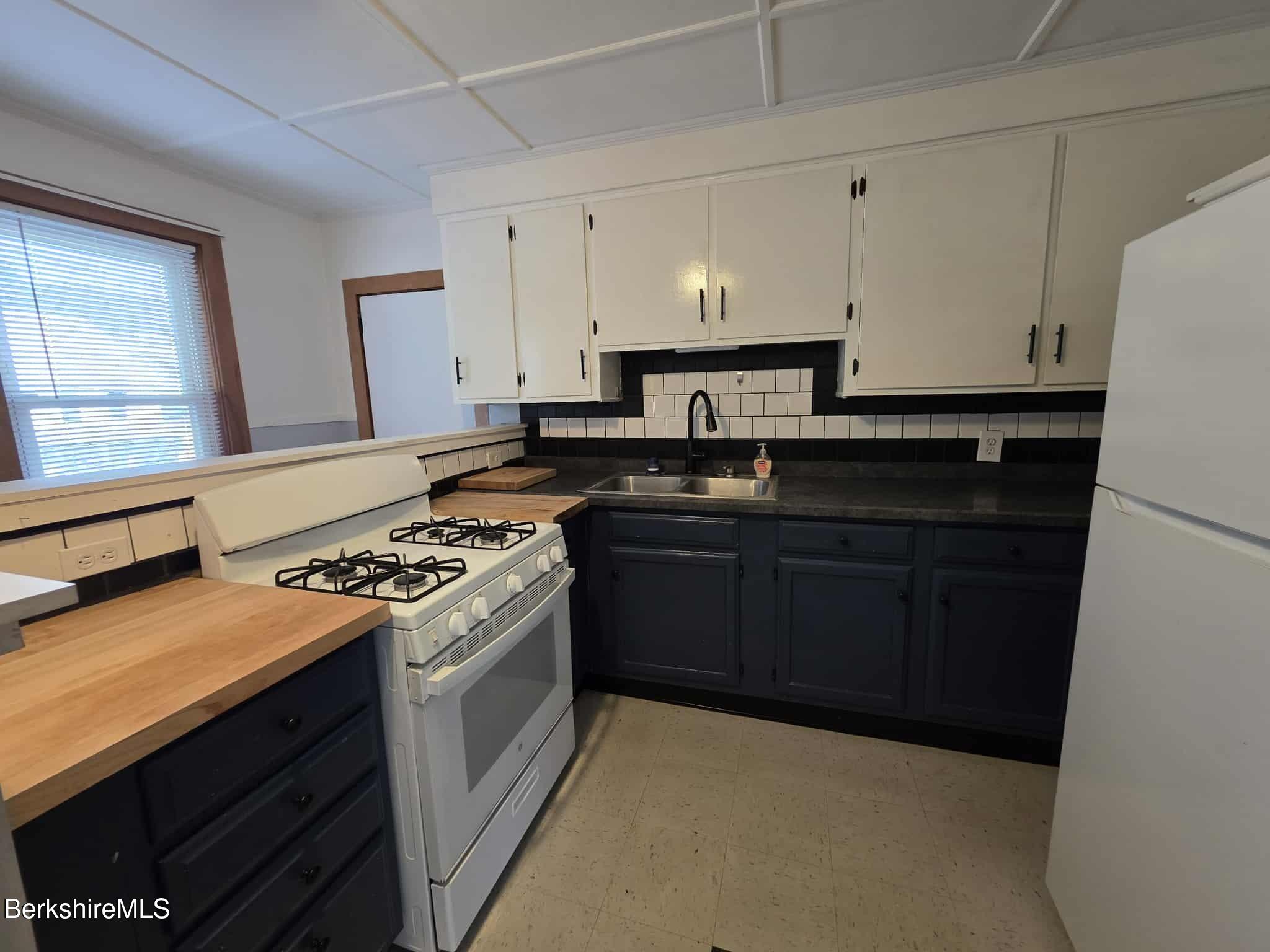 75 North Summer Street, Unit 2 Adams, MA 01220 - Photo 3 of 15 a kitchen with a stove and a refrigerator