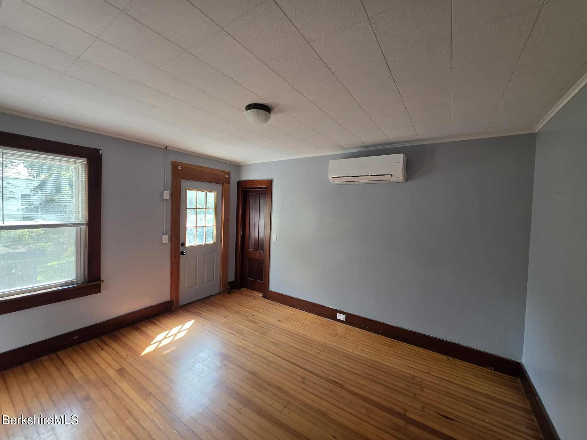 75 North Summer Street, Unit 2 Adams, MA 01220 - Photo 7 of 15 a view of an empty room with wooden floor and a window
