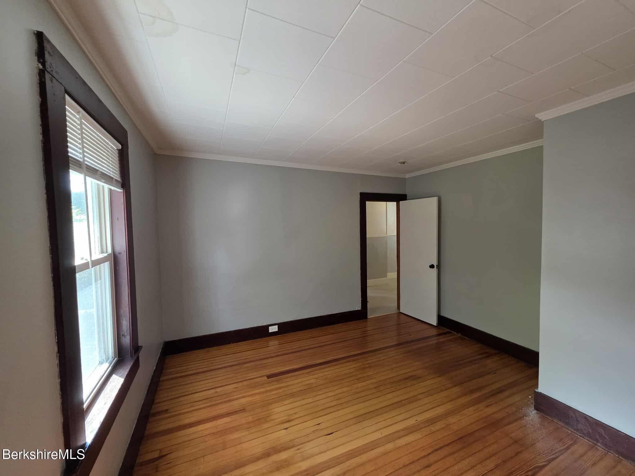 75 North Summer Street, Unit 2 Adams, MA 01220 - Photo 8 of 15 an empty room with wooden floor and windows