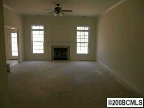 2530 Whitley Road Fort Mill, SC 29708 - Photo 3 of 7 a view of an empty room with a fireplace and a window