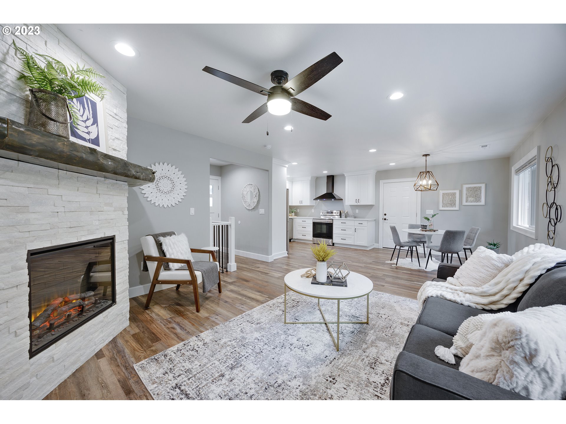 1427 Southeast 109th Avenue Portland, OR 97216 - Photo 11 of 44 a living room with furniture a fireplace and a ceiling fan