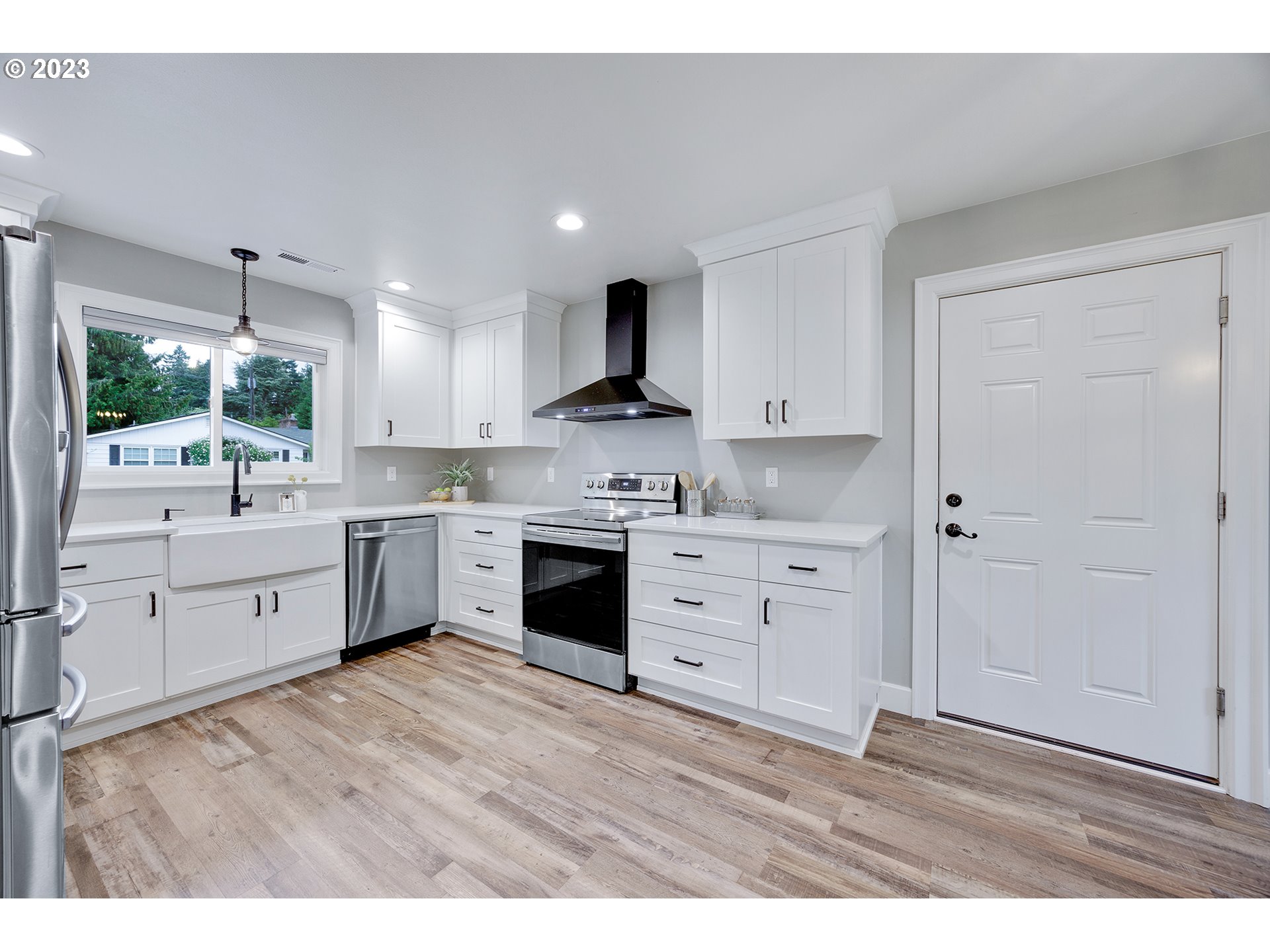 1427 Southeast 109th Avenue Portland, OR 97216 - Photo 15 of 44 a kitchen with white cabinets and stainless steel appliances