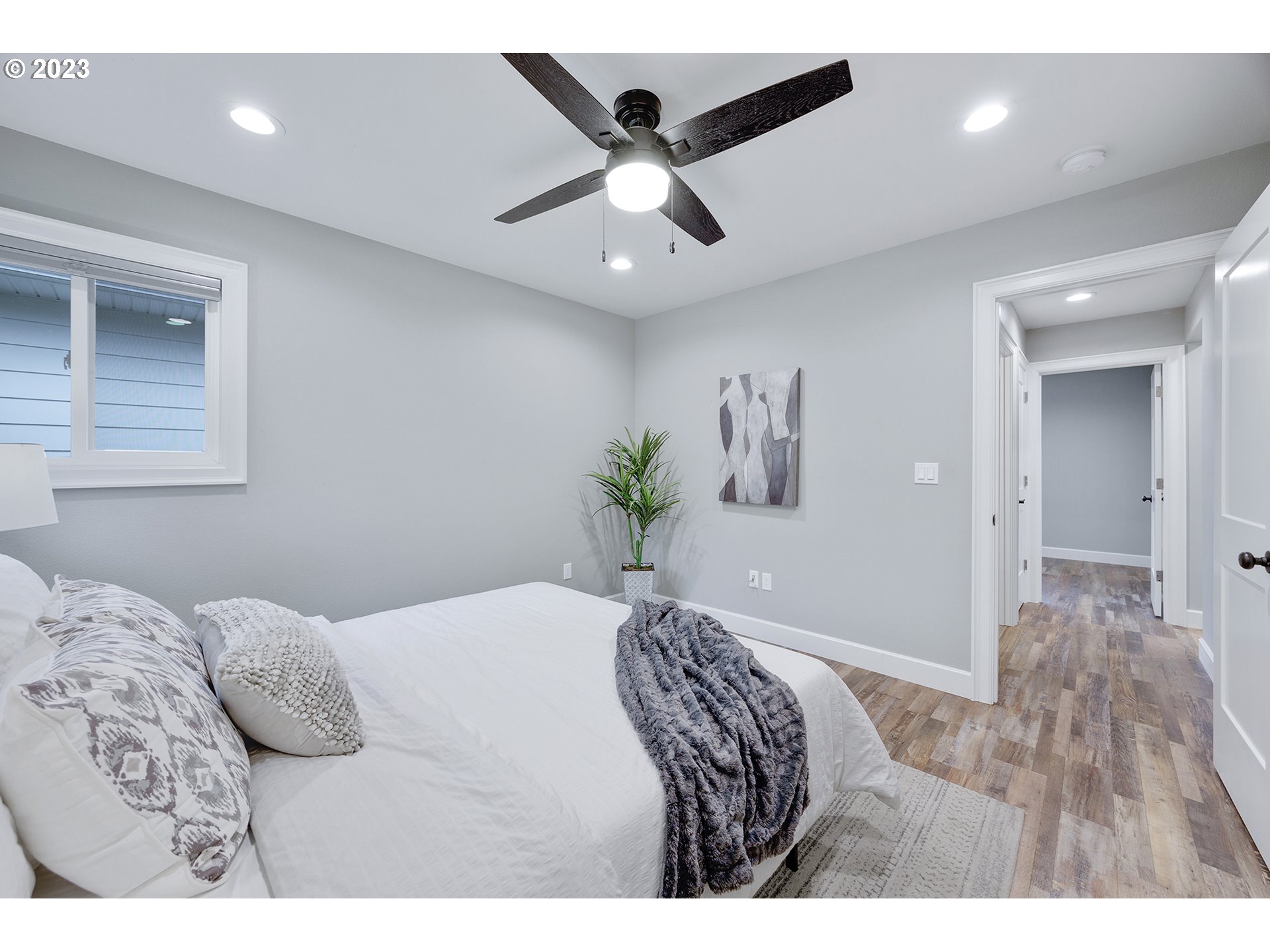 1427 Southeast 109th Avenue Portland, OR 97216 - Photo 24 of 44 a bedroom with a large bed and a chandelier